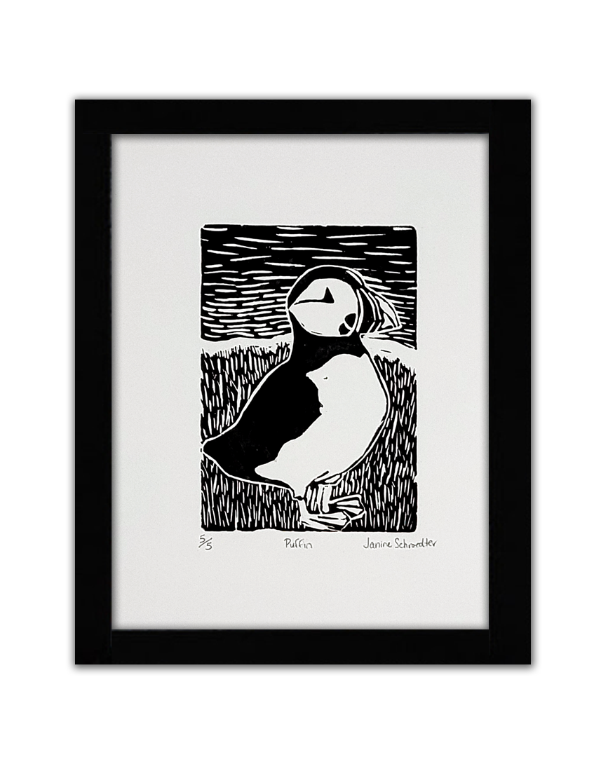 A black linoprint of a puffin in a field